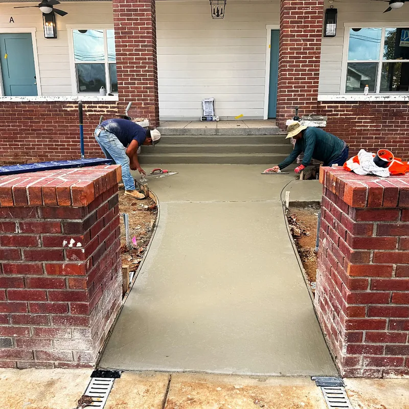 A finished concrete walkway poured by Mountain Landscapers